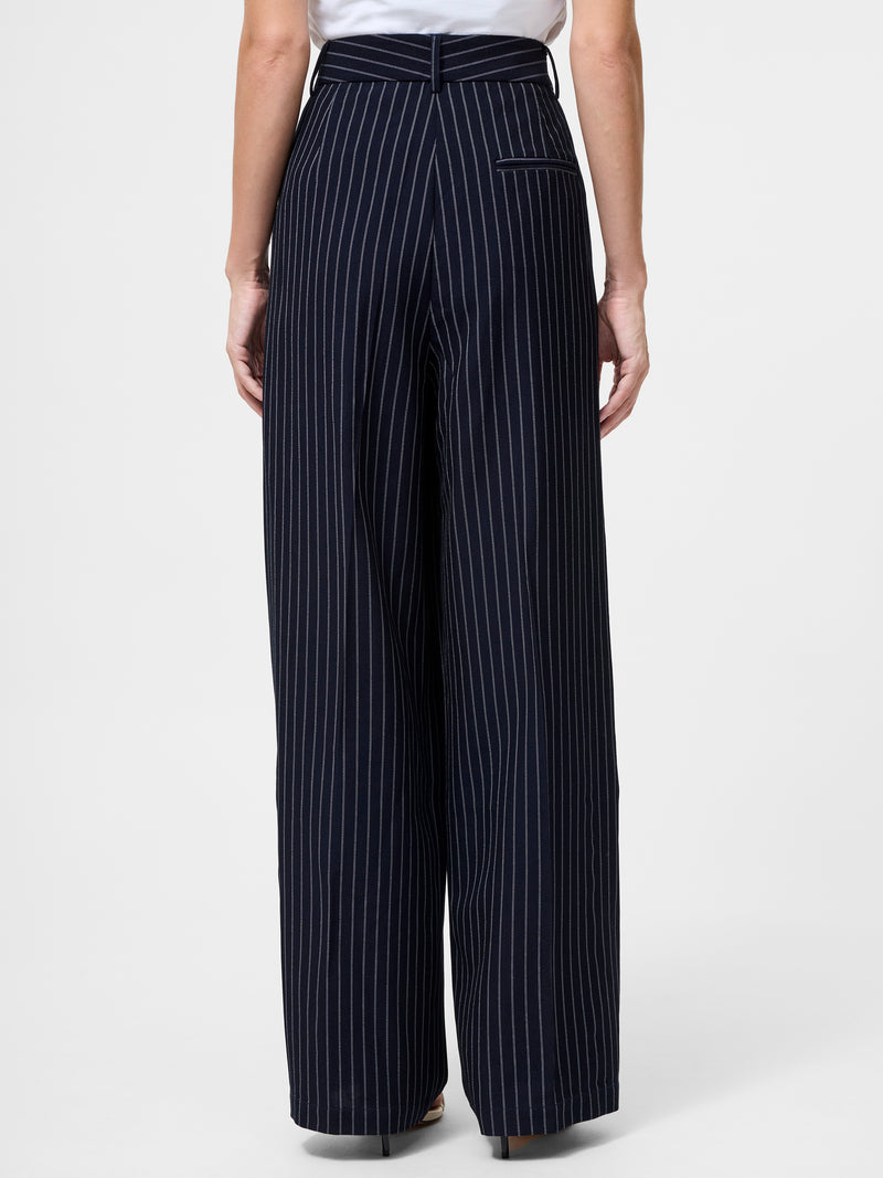 A person is shown from the back wearing Pinstripe Tailored Wide Leg Trousers with white vertical stripes and a single welt pocket on the right, paired with a tucked-in white top.