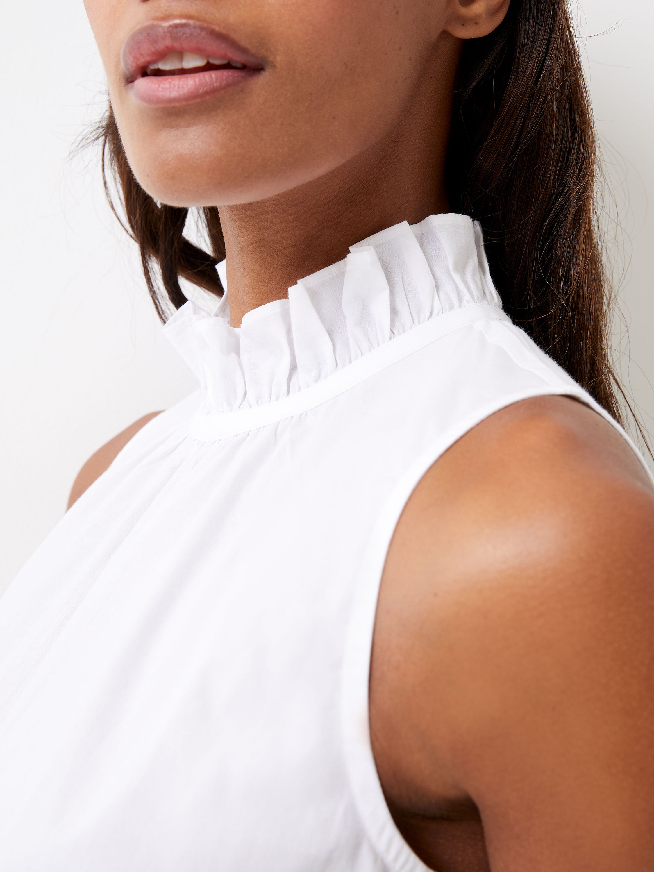 white sleeveless peplum top