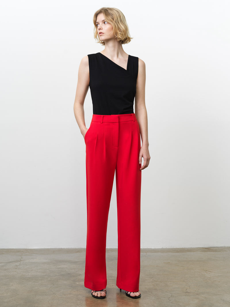 Woman wearing high waisted, wide leg bright red tailored trousers