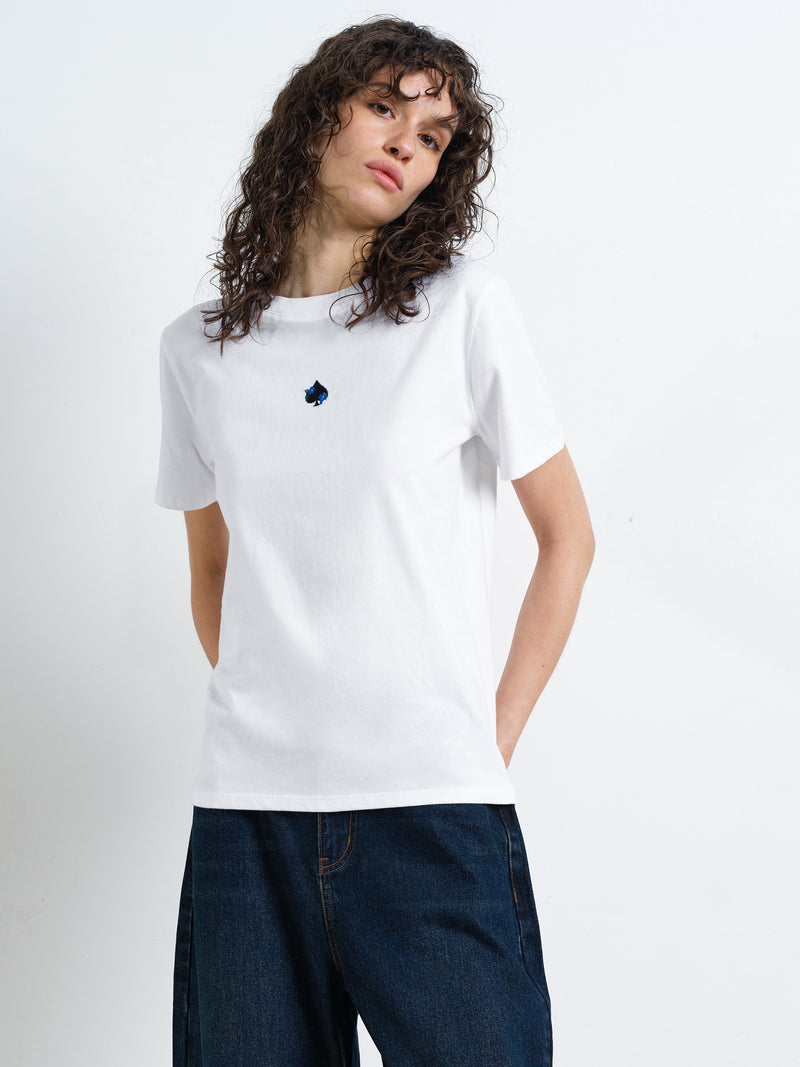 Woman wearing a short sleeve round neck, white T-shirt with an ace of spades and floral back graphic