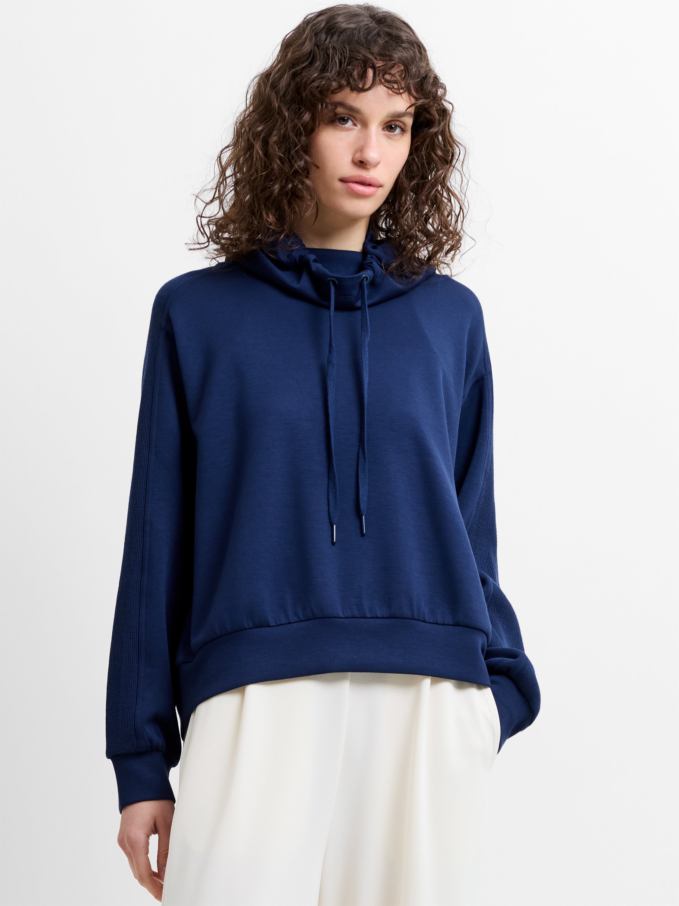 Woman wearing a navy blue drawstring hood sweatshirt